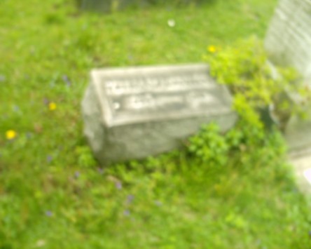 Face by tombstone